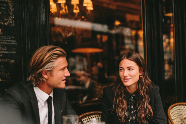 Man and woman having a thoughtful conversation at an outdoor café, representing emotional intelligence