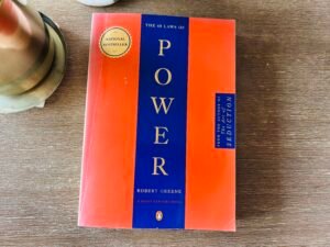 Flat lay of The 48 Laws of Power book on a wooden table