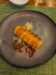Crispy Japanese spring roll with sprouts and sauce served at Olio Cancun Playa’s sushi restaurant.