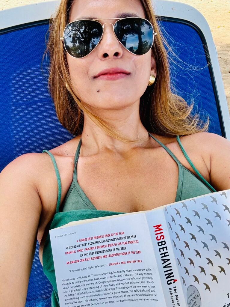 Woman reading a book outdoors, reflecting on personal growth, writing, and an intentional lifestyle.
