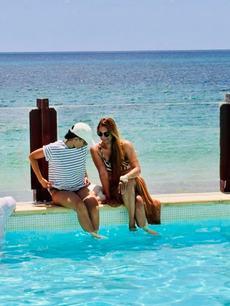 Family relaxing by the pool during travel, representing time freedom and presence