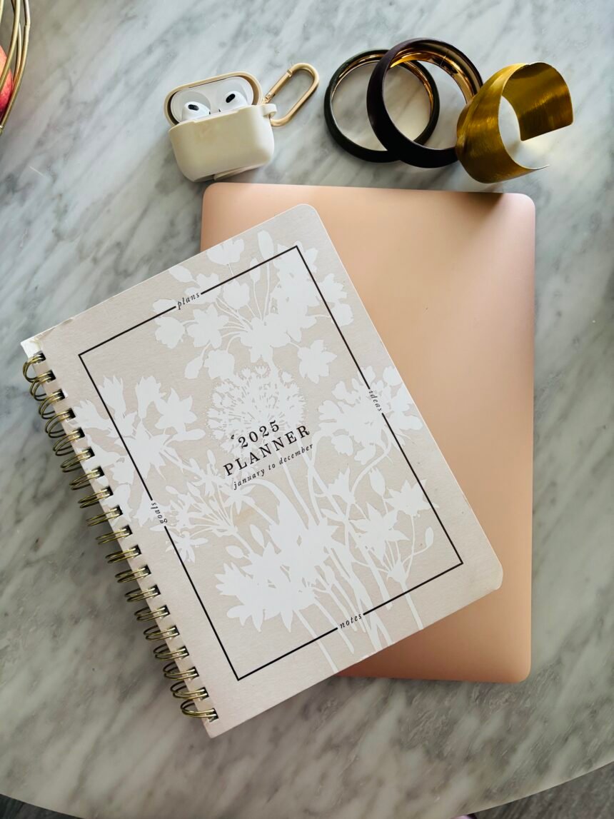 Minimal planner and laptop setup representing systems and structure for entrepreneurial success