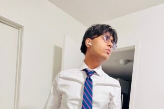 Teenage son dressed professionally, representing preparedness, discipline, and values learned through parenting by example