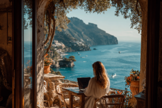 Beginner investor working on laptop with scenic ocean view representing financial freedom through ETF investing