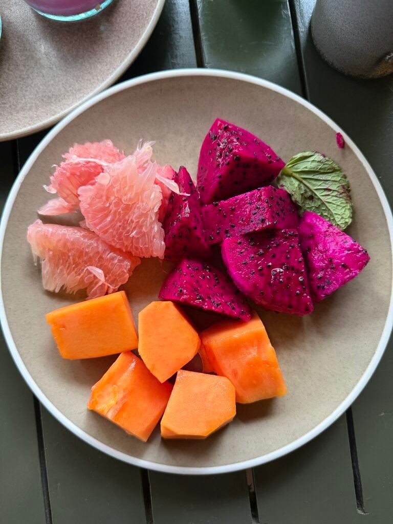 Fresh tropical fruit bowl with dragon fruit papaya and grapefruit in Bali