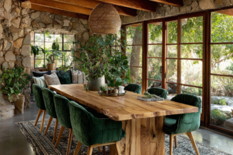 natural wood dining table with green velvet chairs warm cozy home interior design