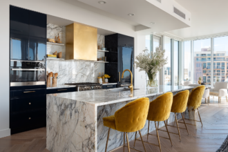 gold mustard velvet bar stools at marble kitchen island with brass accents