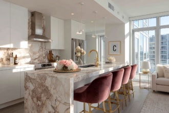 Modern kitchen with marble island and velvet bar stools with gold legs