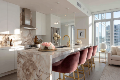 Modern kitchen with marble island and velvet bar stools with gold legs