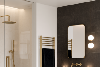Beautiful modern powder room with gold mirror and brass fixtures