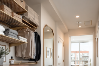 Walk-in closet with gold rods and a collection of elegant handbags.